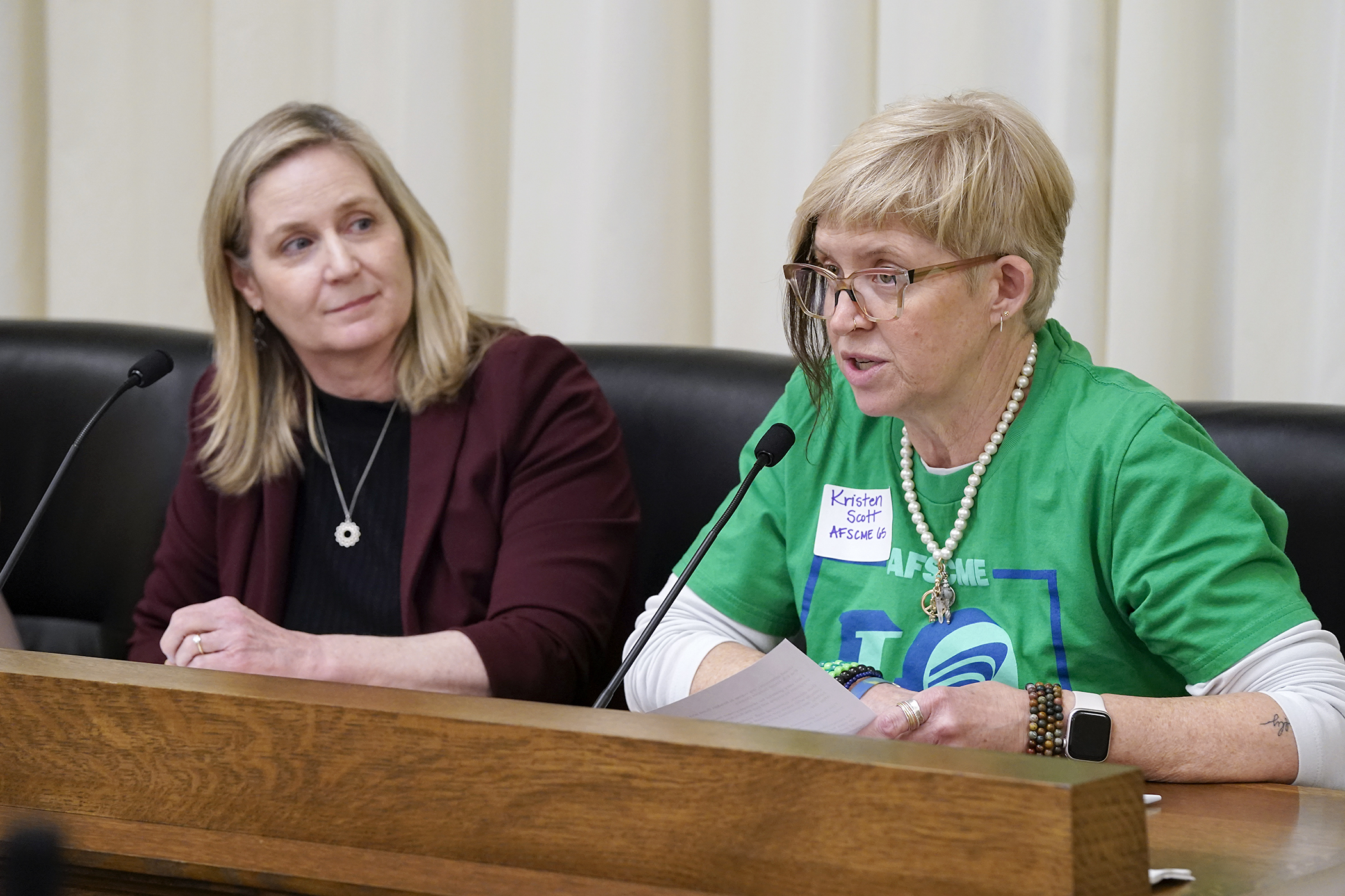 Kristen Scott with AFSCME Council 65 testifies in support of HF2210 before the House Education Finance Committee March 20. The bill, sponsored by Rep. Lucy Rehm, left, would provide additional funding for school unemployment aid. (Photo by Michele Jokinen)